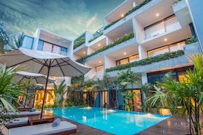 A modern hotel with a rooftop pool, outdoor seating, and lush greenery. - Apsara Residence Hotel (Siem Reap)