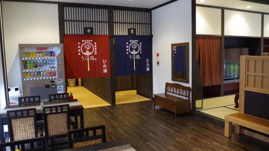 A room with a vending machine, a tatami mat area, and a traditional Japanese sliding door.