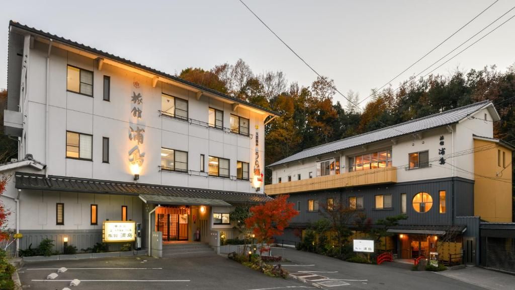 A two-story building with a traditional Japanese architectural style, featuring a large entrance and a signboard.