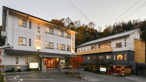A two-story building with a traditional Japanese architectural style, featuring a large entrance and a signboard. - Urayu Ryokan Urashima (Onomichi)