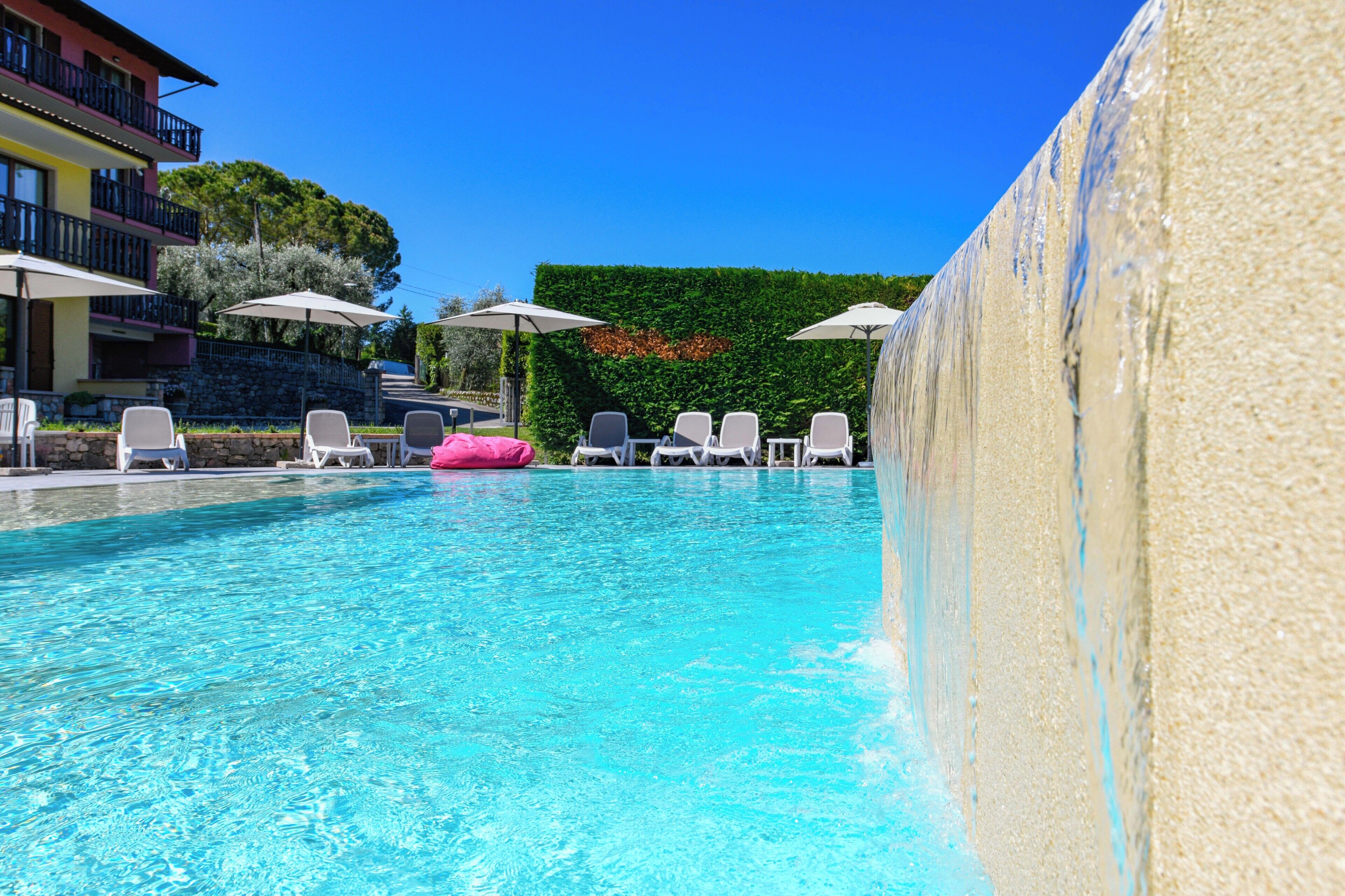 Seasonal outdoor pool, pool umbrellas, pool loungers