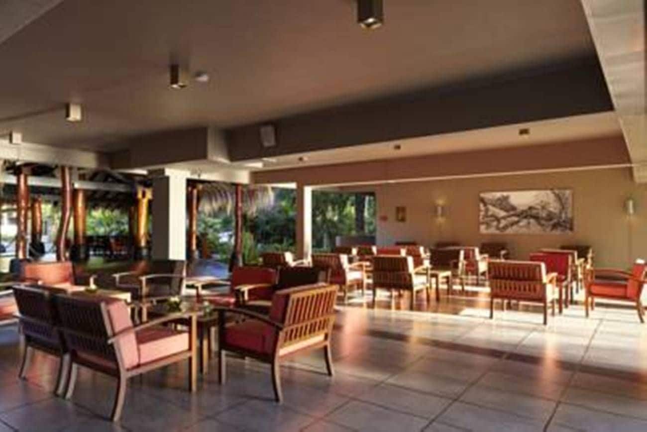 A spacious indoor area with multiple seating arrangements and large windows allowing natural light.