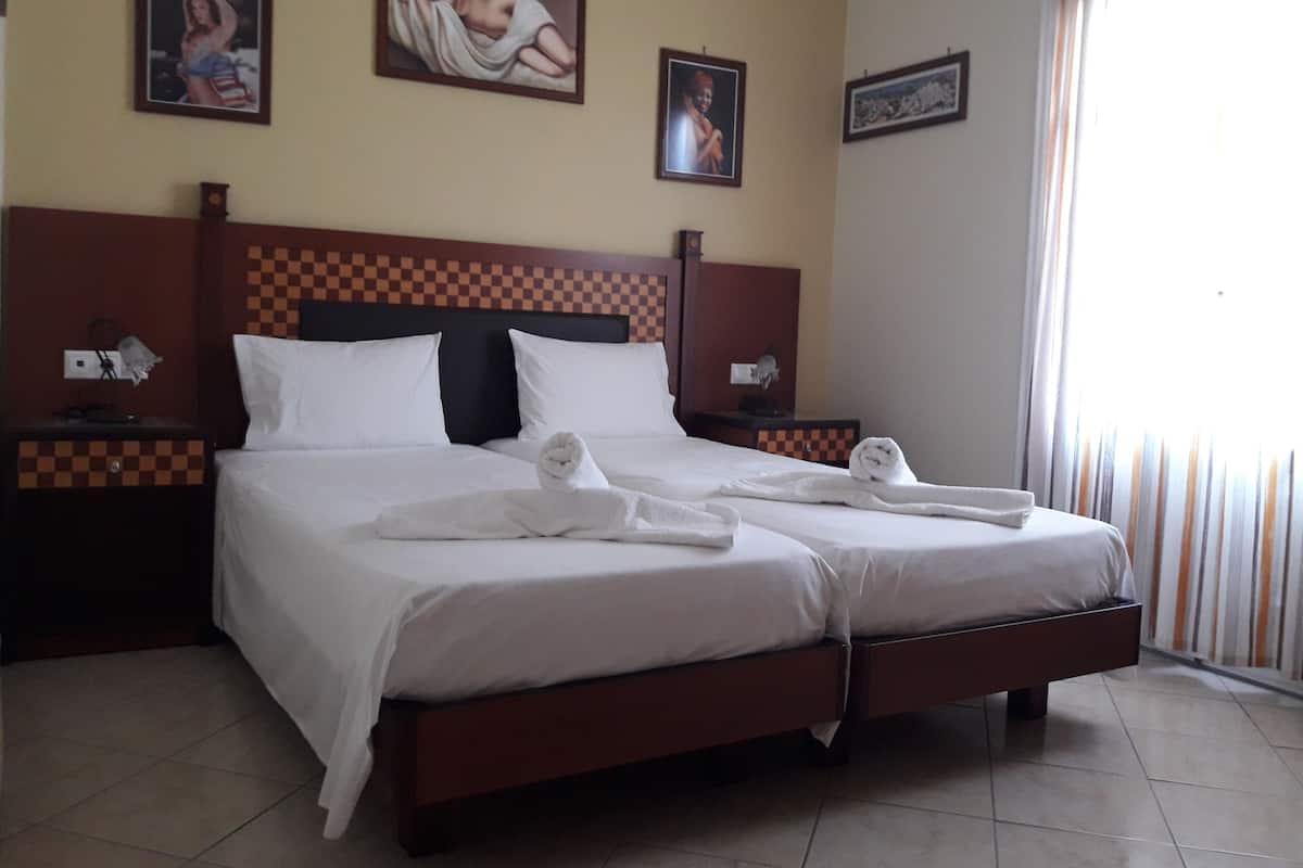Twin Room, City View | Minibar, in-room safe, laptop workspace, iron/ironing board