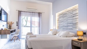 Une chambre d’hôtel moderne, dotée d’un grand lit, d’un bureau avec une chaise, d’une télévision et d’une fenêtre avec des rideaux.
