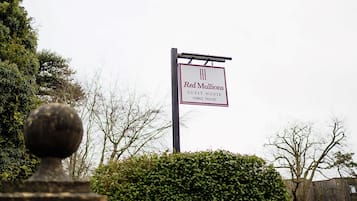 A sign for "Red Mullions Guest House" with a contact number.