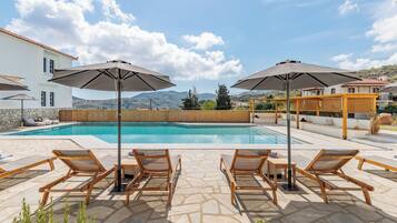 Outdoor pool, open 9:00 AM to 9:00 PM, pool umbrellas, pool loungers