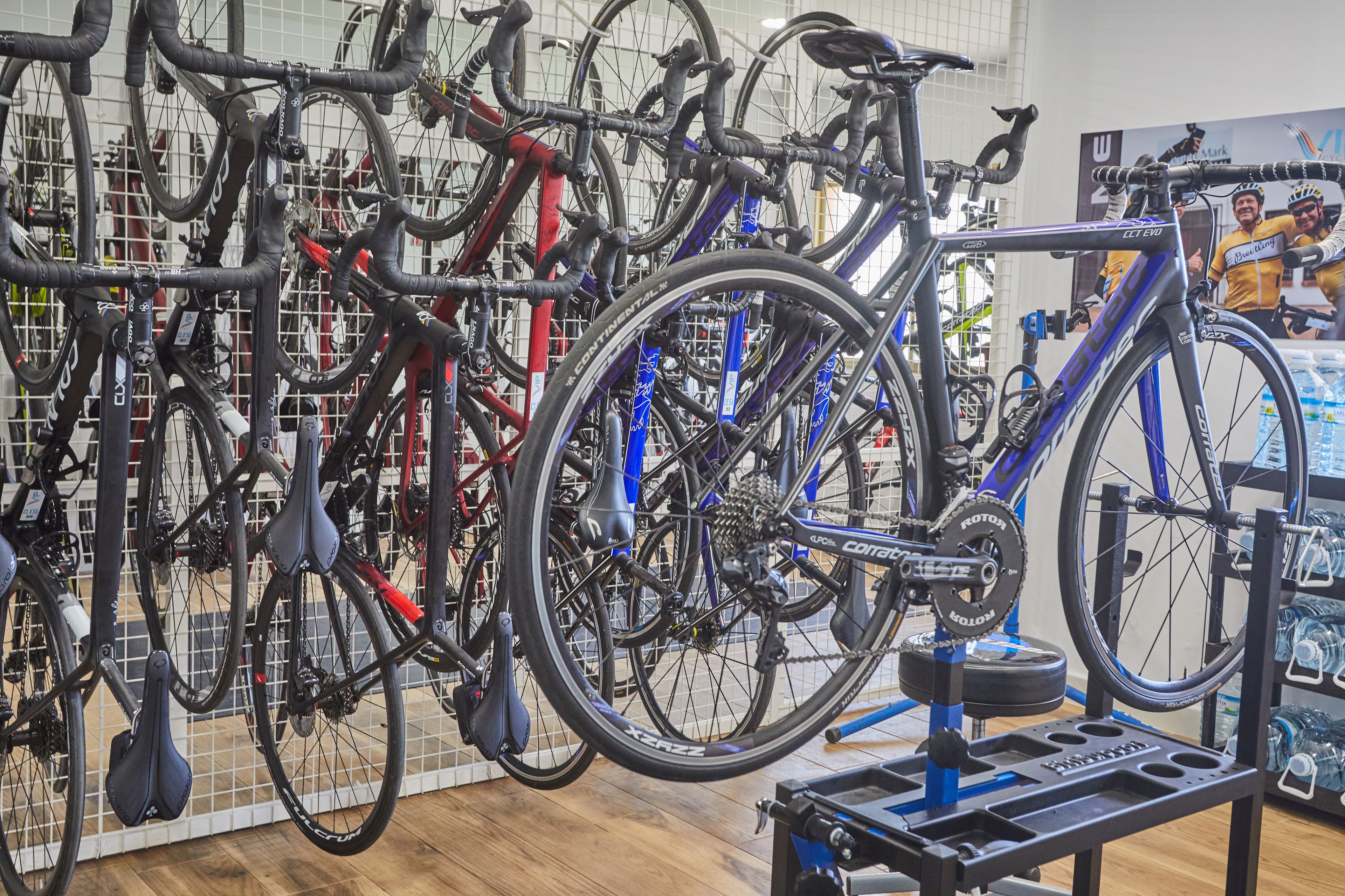 A bicycle shop with multiple bicycles on display and a bike repair stand.