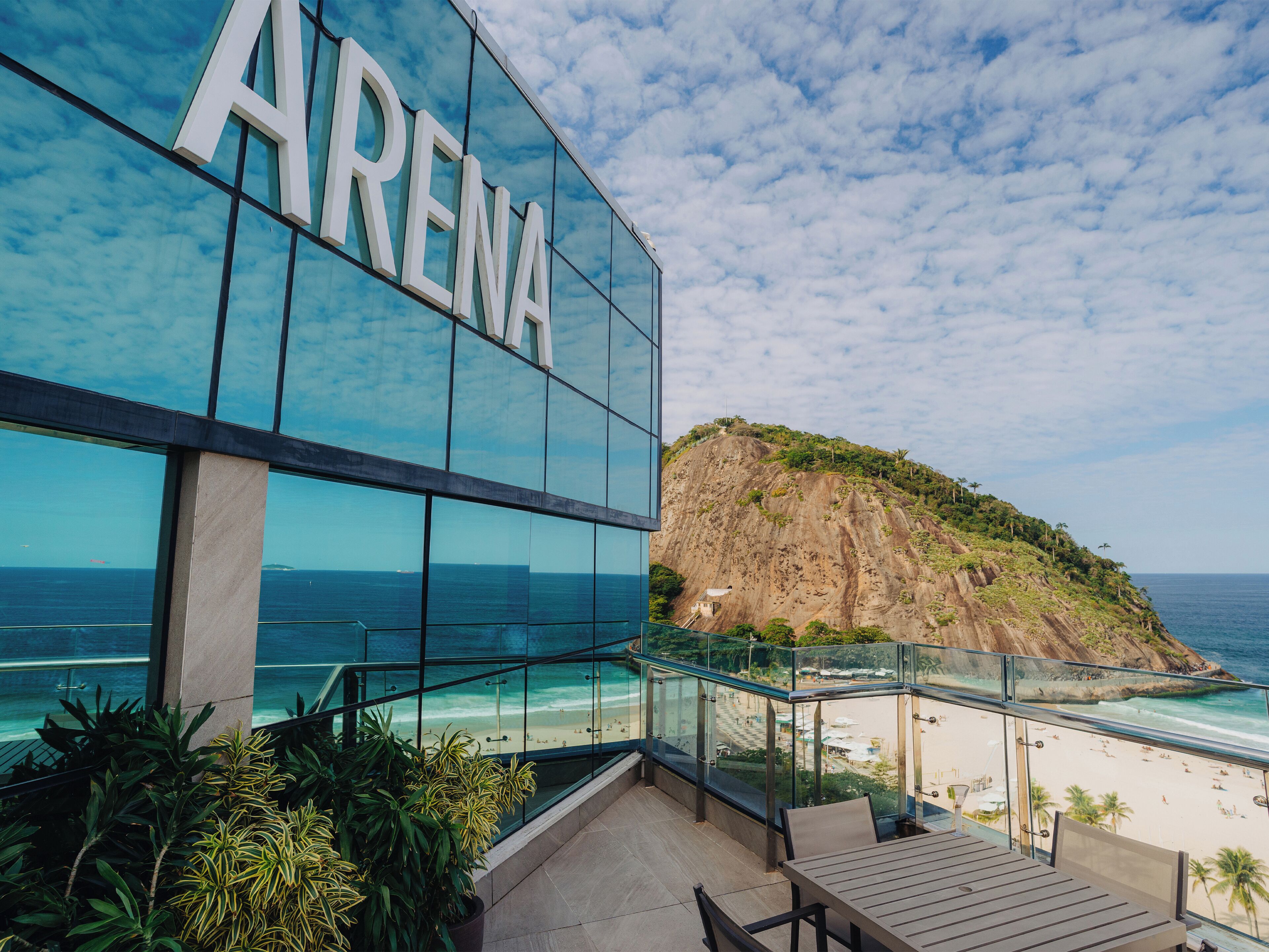 A modern building with a large glass facade and the word "ARENA" prominently displayed.