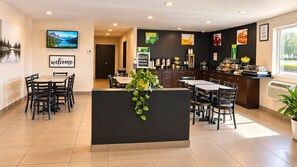 A hotel lobby with a reception desk, seating area, and a kitchenette. - Quality Inn & Suites near Downtown Bakersfield (Bakersfield)