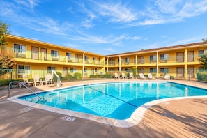 A hotel with a swimming pool, multiple balconies, and outdoor seating. - Quality Inn & Suites near Downtown Bakersfield (Bakersfield)