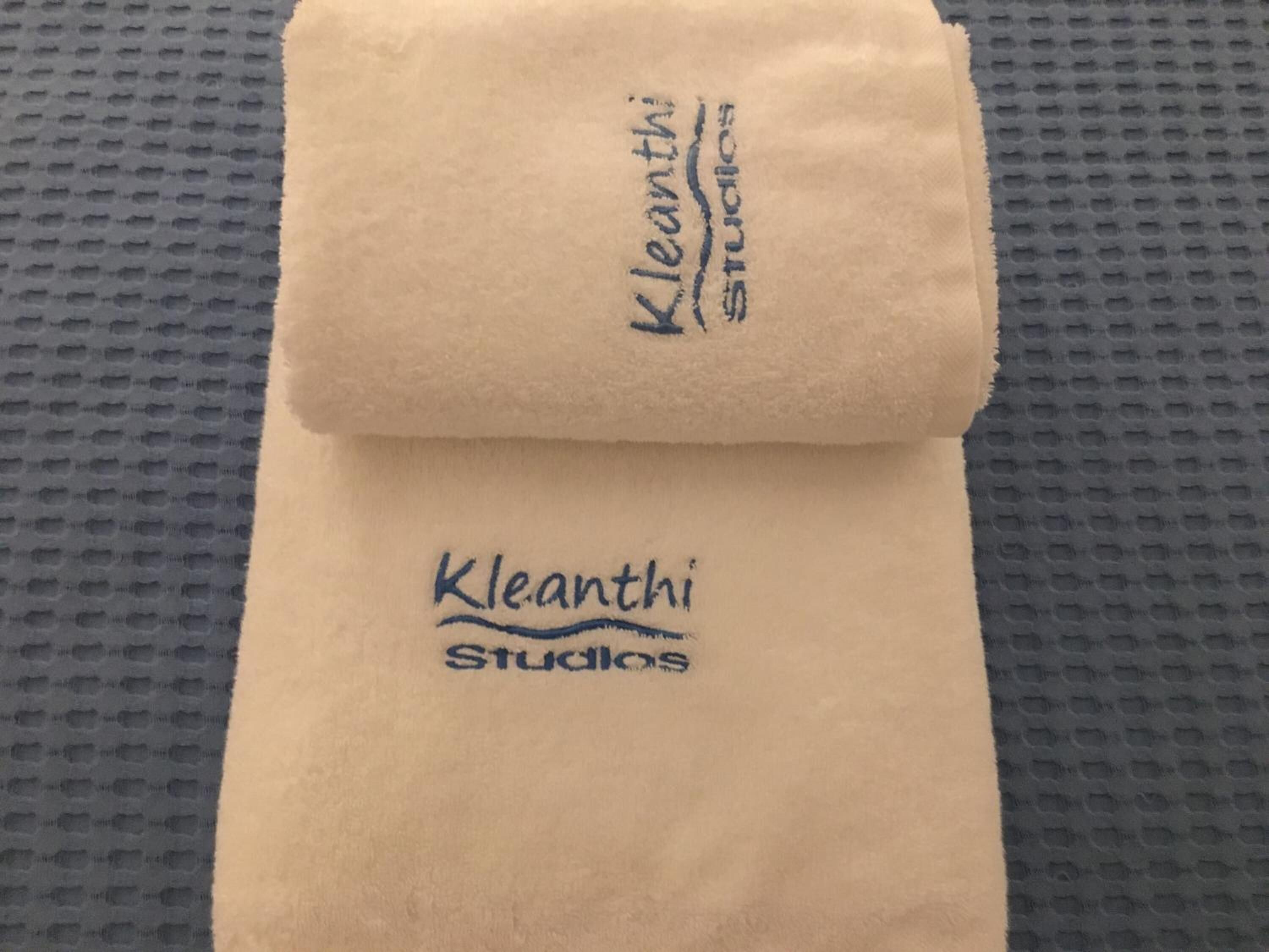 A folded towel with 'Kleanth Studios' printed on it.