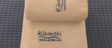 A folded towel with 'Kleanth Studios' printed on it.