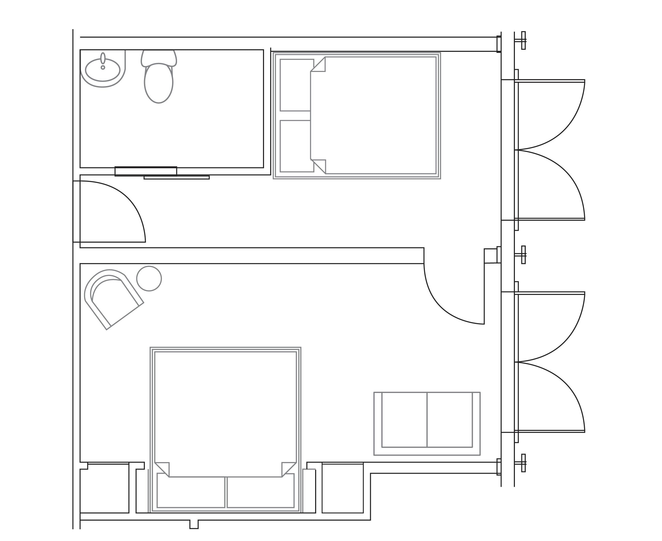 A floor plan of a hotel room with a bathroom, a small sitting area, and a bed.