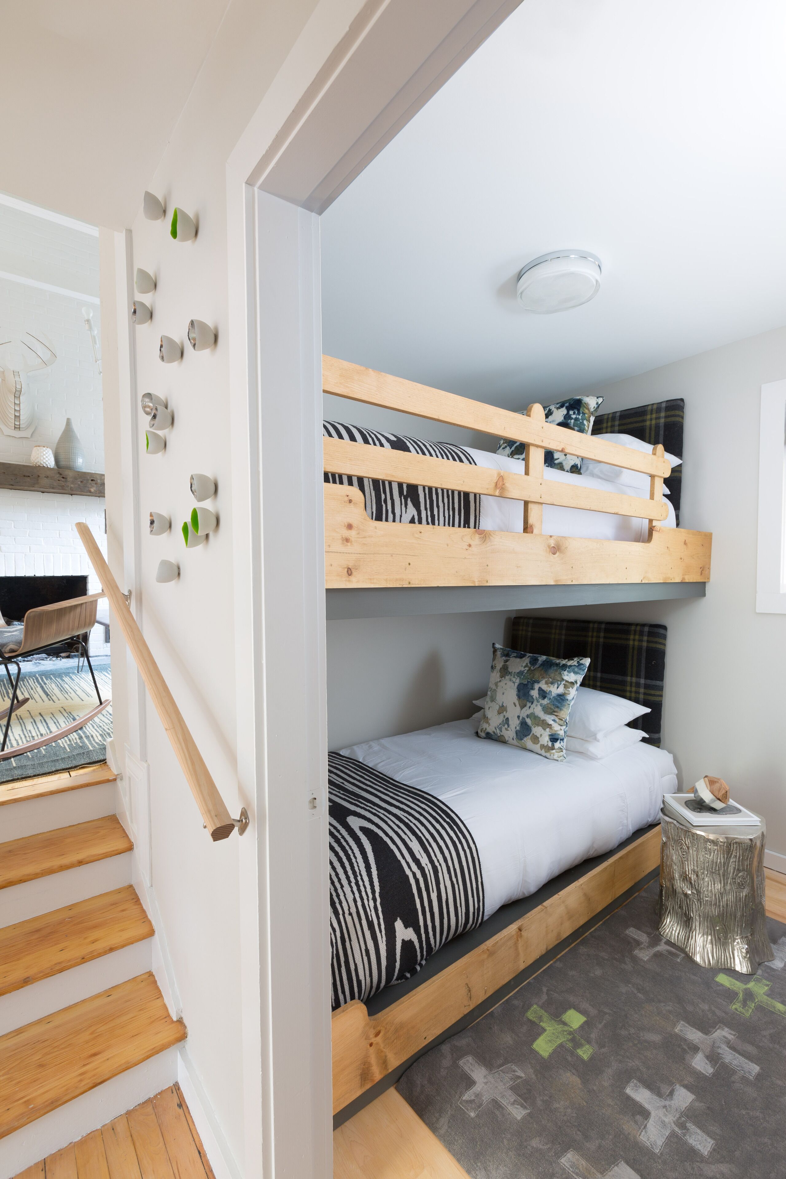 A room with a bunk bed, a desk, and a chair.