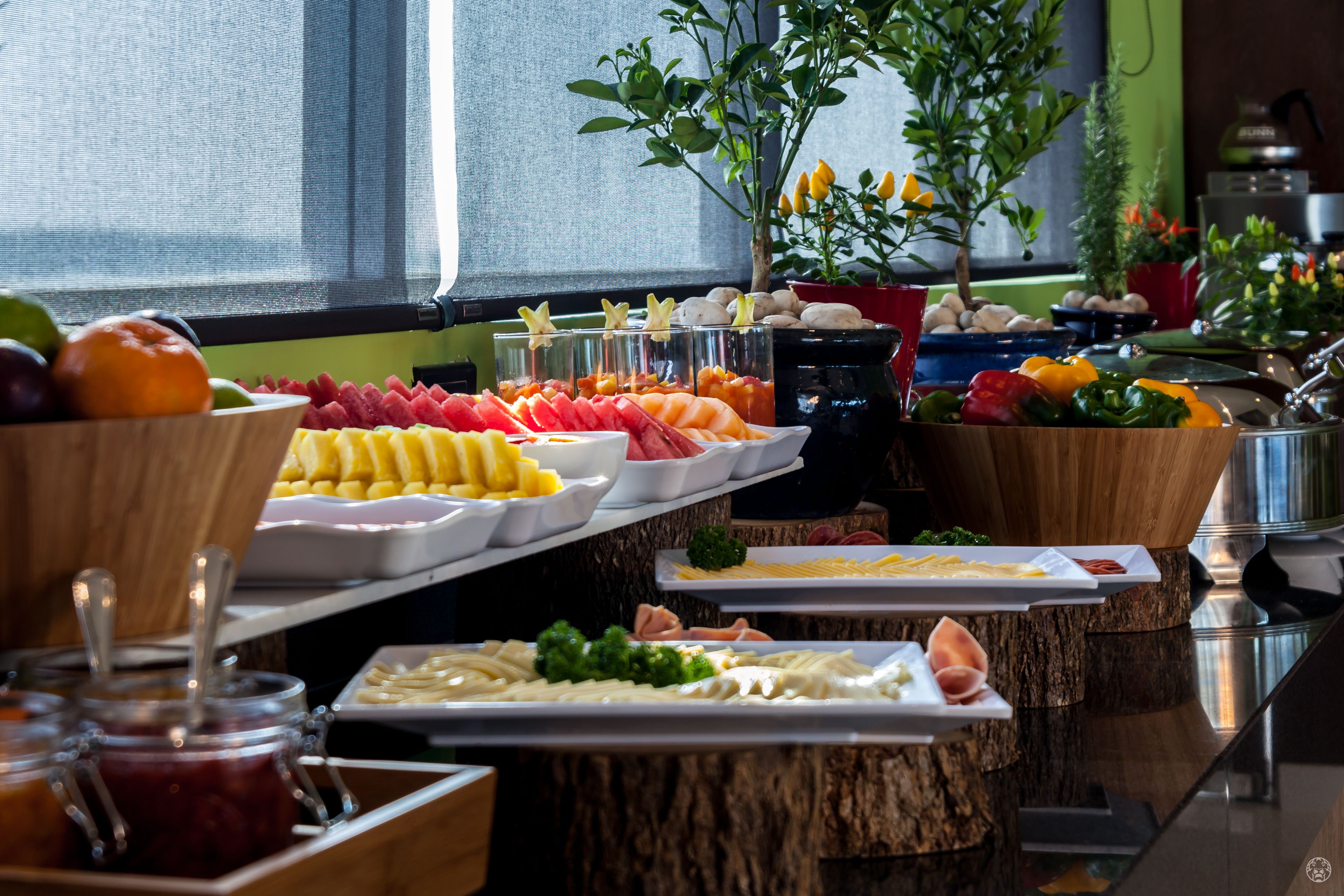 A buffet with various food items including fruits, vegetables, and meats.