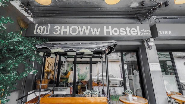The exterior of a hostel with a sign reading "3HOWw Hostel" and a number "3165". - Bangkok Nomad Hostel (Bangkok)