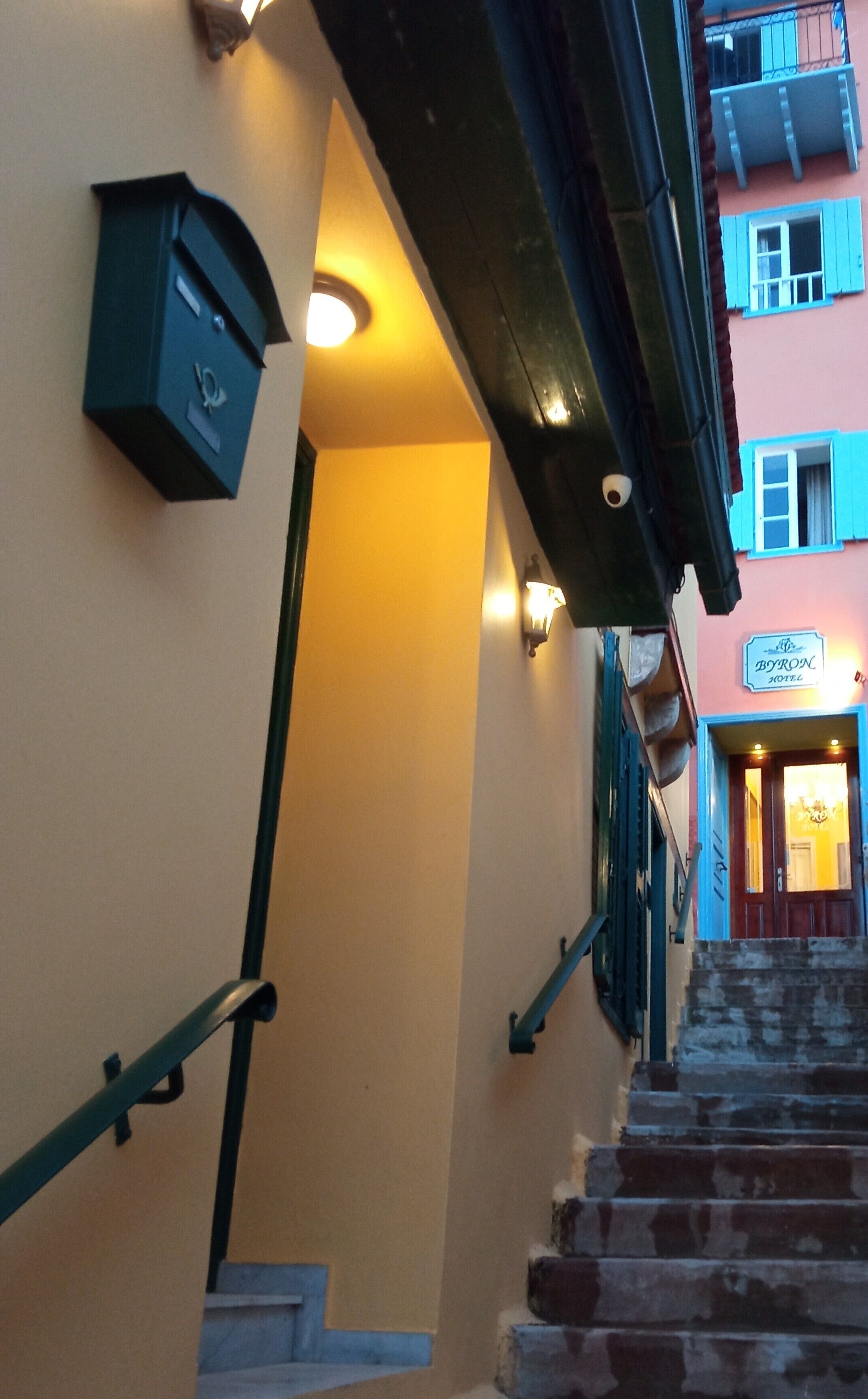 A staircase leading to a hotel entrance with a sign reading "Byron Hotel".