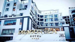 A modern hotel building with a prominent sign reading "DRAGON SEA HOTEL". - Dragon Sea Sam Son Hotel (Sam Son)