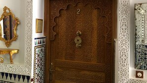 A wooden door with intricate carvings and a number '2' on it. - Malabata Guest House (Tangier)