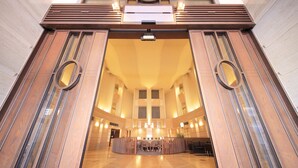 A spacious lobby with a central seating area, a high ceiling, and a modern design. - Quintessa Hotel Sapporo (Sapporo)