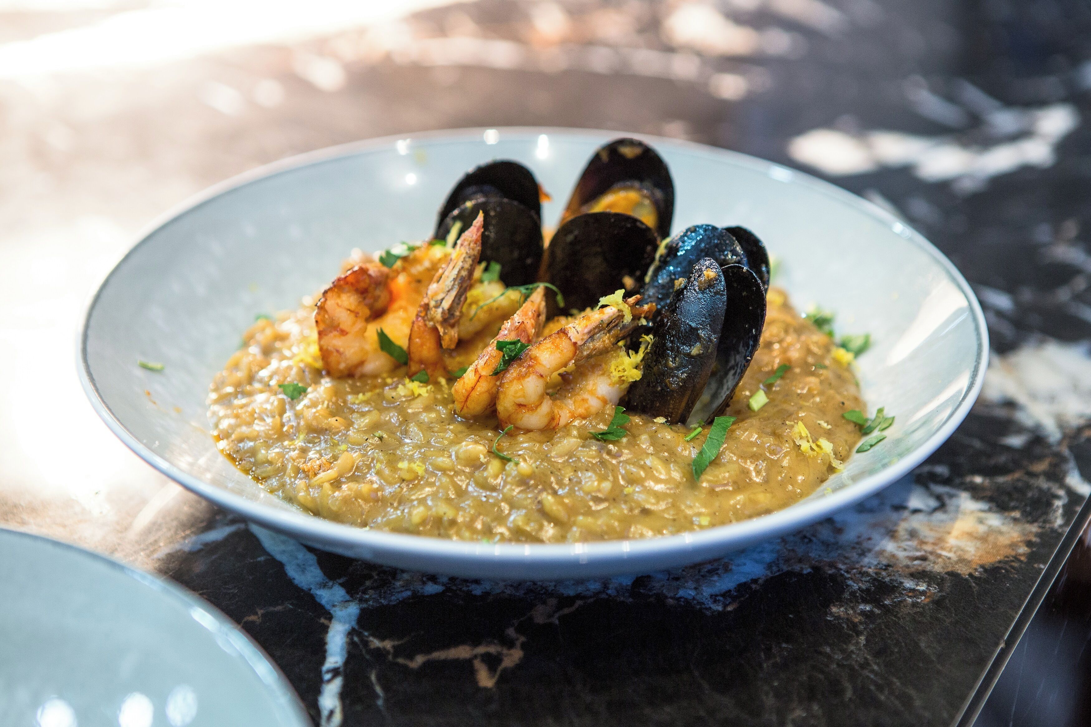 A seafood dish with mussels and shrimp on a plate.