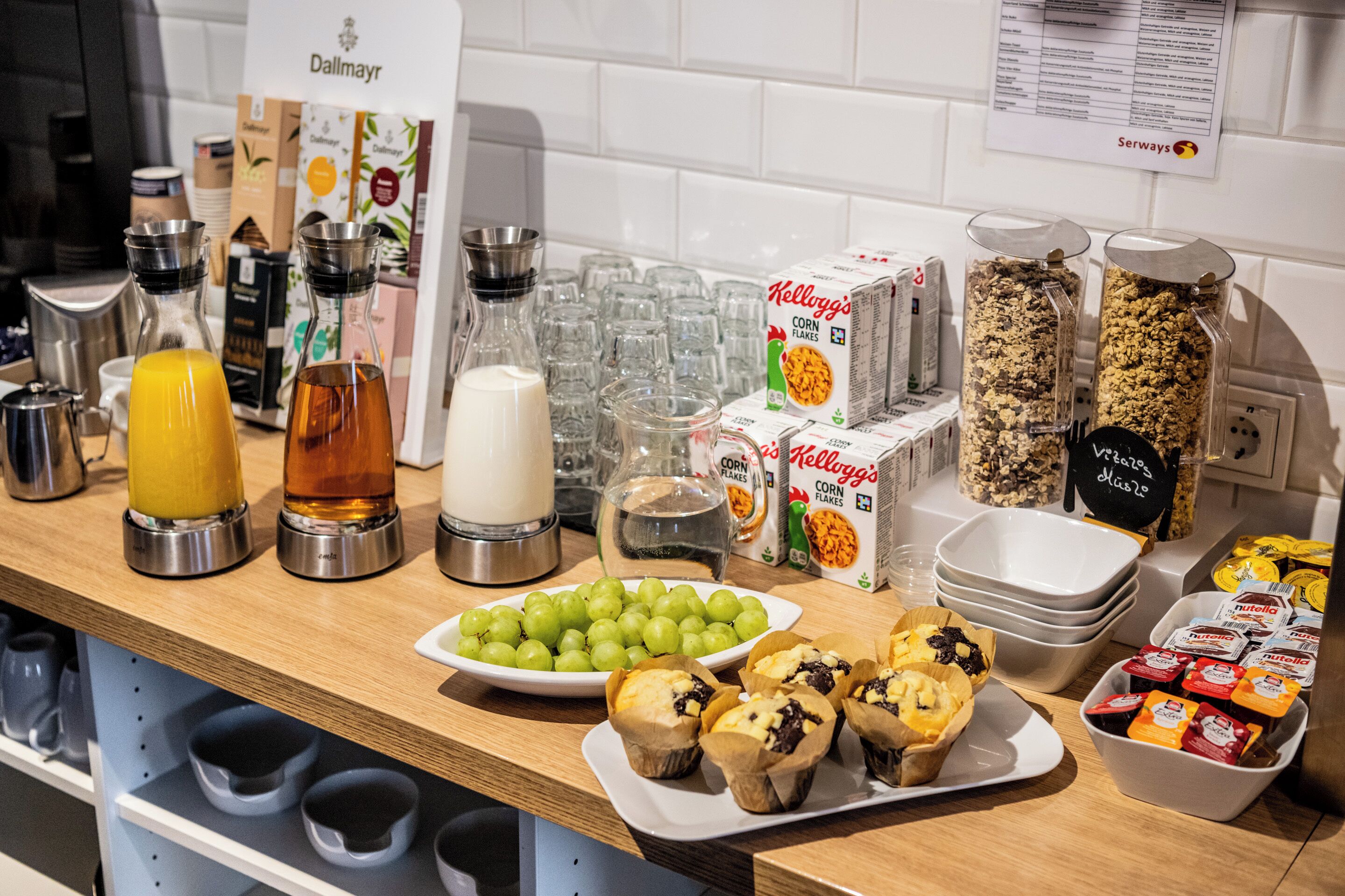 A breakfast buffet with various food items and beverages.