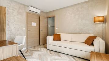 Superior Quadruple Room, Multiple Beds | Living area | Flat-screen TV