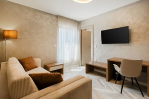 Superior Quadruple Room, Multiple Beds | Living area | Flat-screen TV