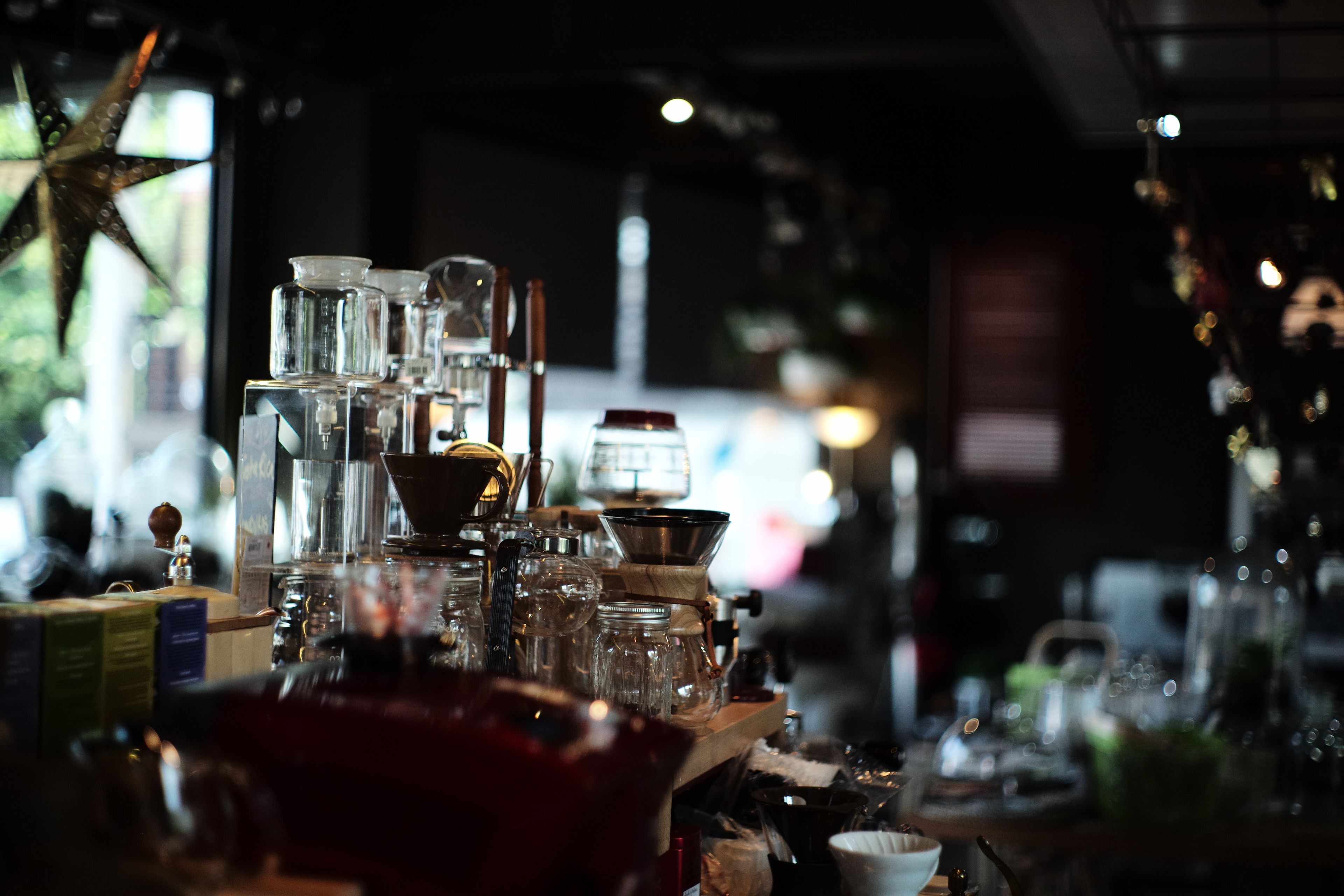 A bar area with various glassware and bottles, a coffee machine, and a star decoration on the wall.