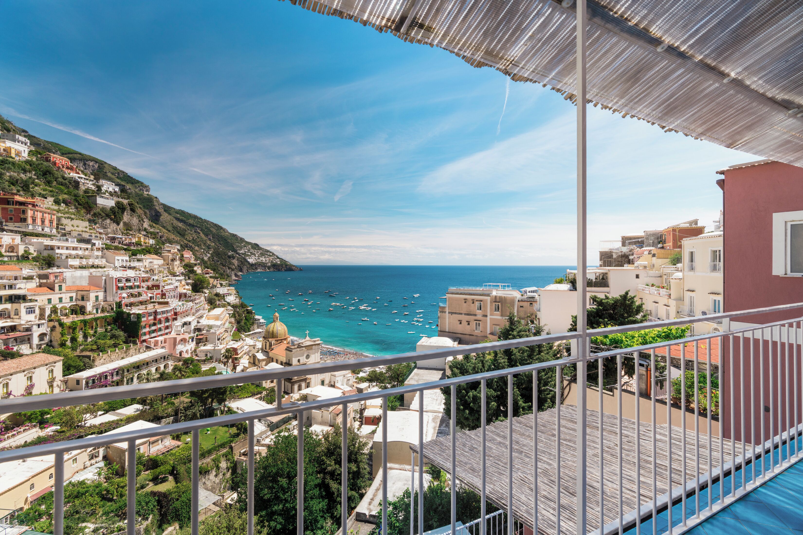 A coastal town with buildings along the hillside and a view of the sea.
