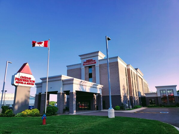 A hotel with a prominent sign for Chateau Fredericton Hotel & Suites. - Chateau Fredericton, Trademark Collection by Wyndham (Fredericton)