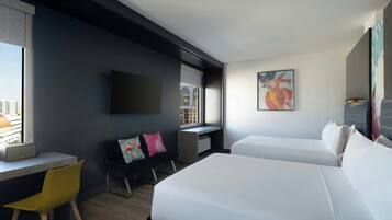 A modern hotel room with a large bed, a desk, a chair, and a TV mounted on the wall.