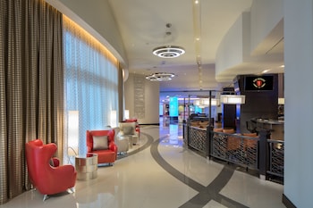 Experience a sleek, contemporary lobby with a curved reception desk and comfortable seating area. at Parkwest Bicycle Casino