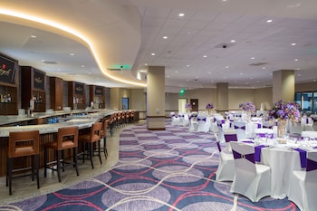 A modern hotel with a swimming pool, sun loungers, and a glass-enclosed balcony. at Parkwest Bicycle Casino