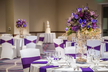Formal events are hosted in this elegant banquet hall with tables set for guests, featuring white tablecloths and silverware. at Parkwest Bicycle Casino