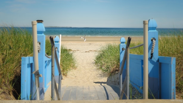 A beach pathway leading to the shore with a clear view of the sea and distant land. - Friendship Oceanfront Suites (Old Orchard Beach)