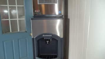 A stainless steel refrigerator with a water dispenser labeled "Scotsman" in a kitchen setting.