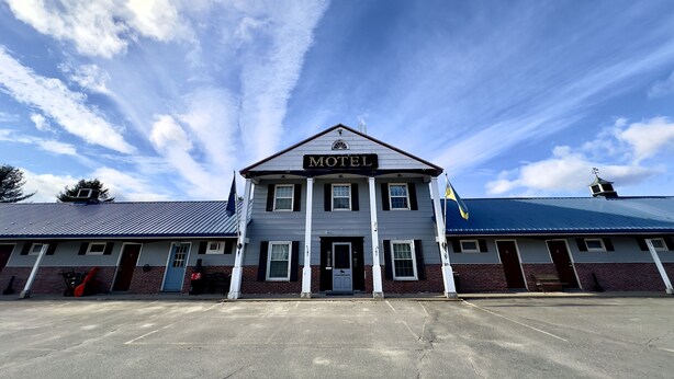 A two-story building with a sign reading "HOTEL" above the entrance.