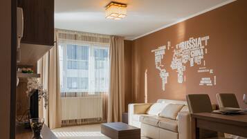 Superior Apartment, 1 Bedroom, Balcony | Living area | Flat-screen TV