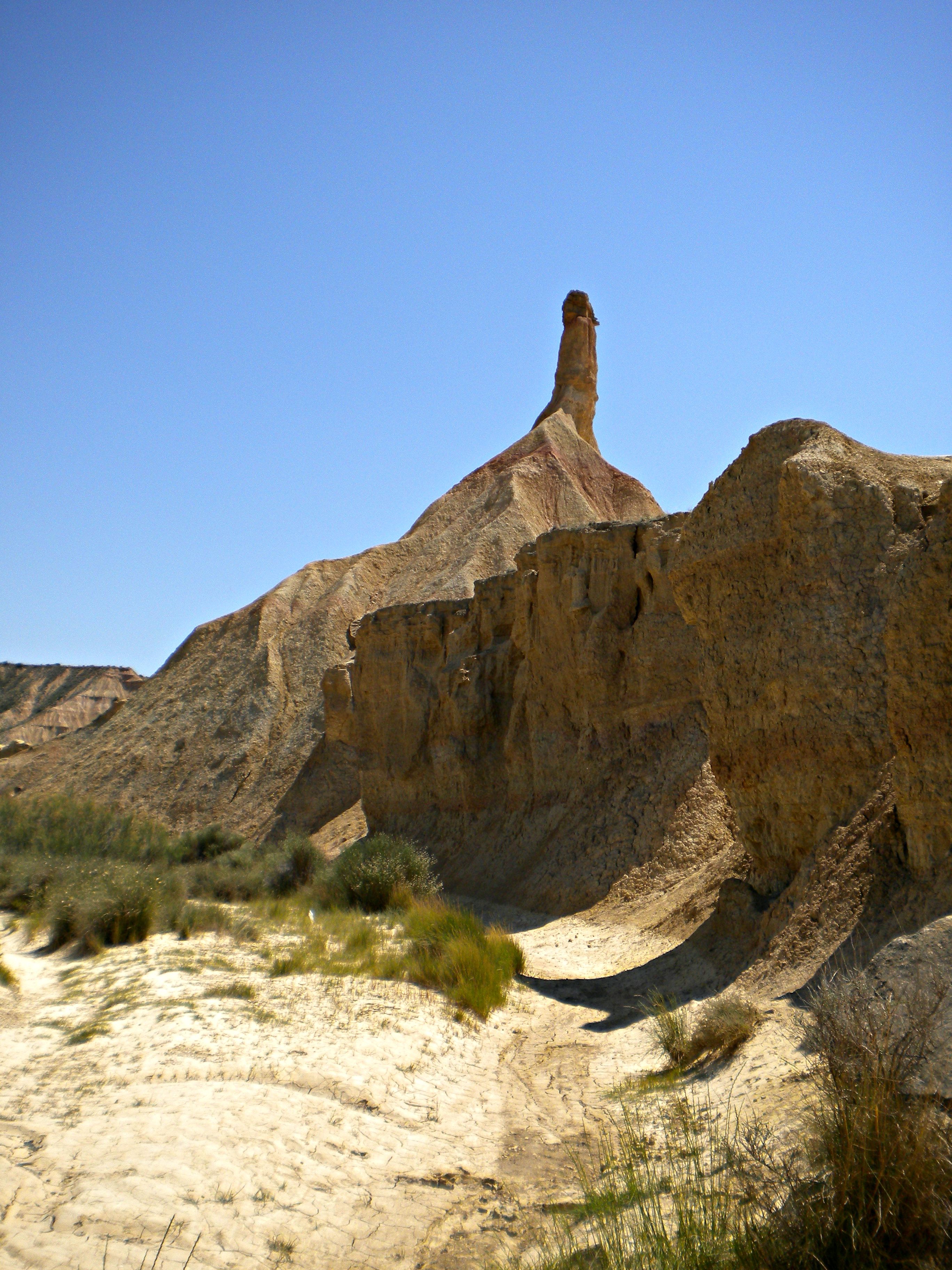 A desert landscape with a prominent rock formation.