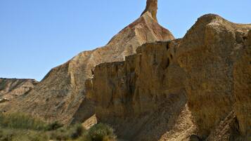 A desert landscape with a prominent rock formation.
