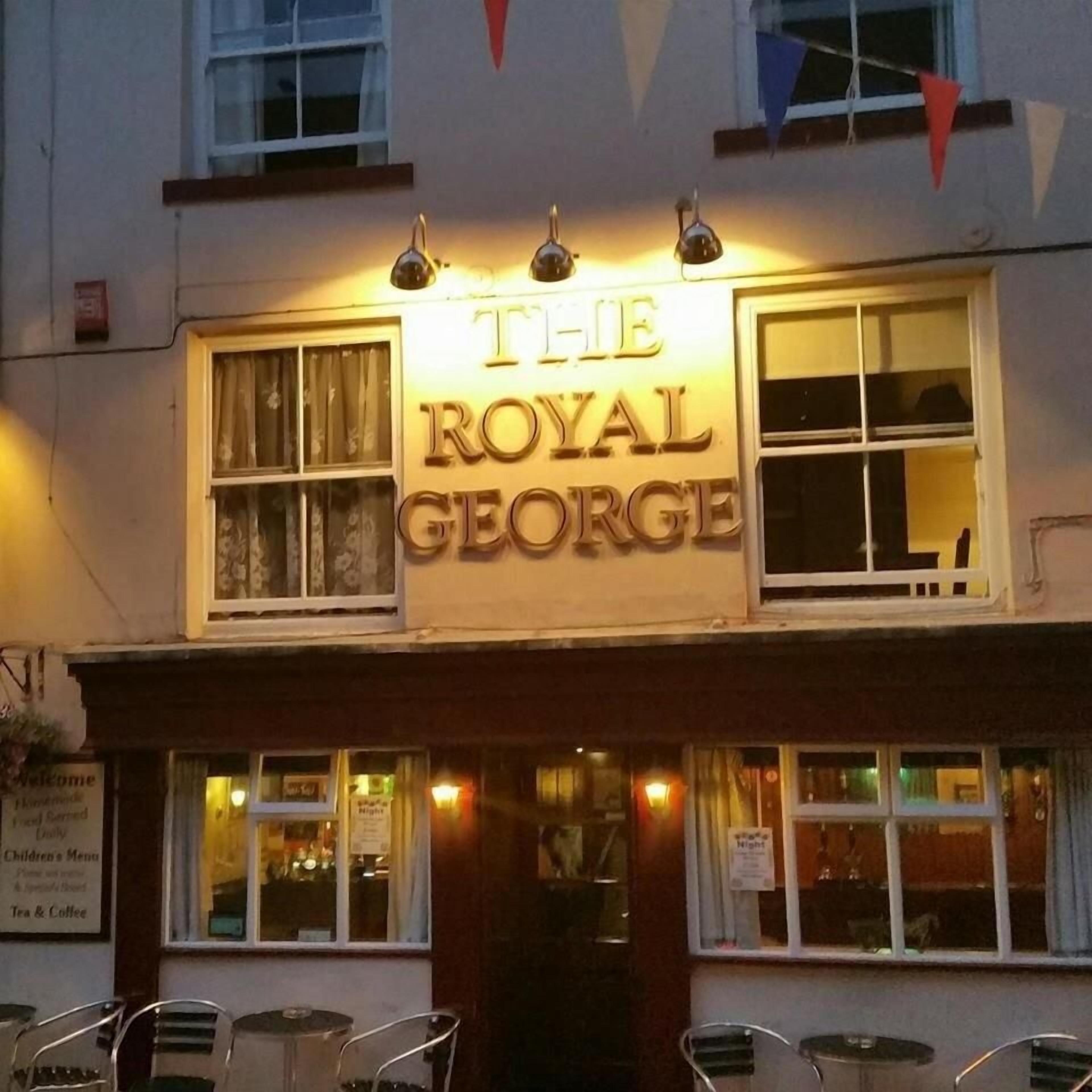 A building with a sign that reads 'The Royal George.'