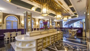 A luxurious lobby with a marble floor, elegant furniture, and a central island with a vase of flowers. - Park View Hotel (Bandung)