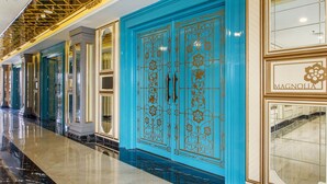 A corridor with blue doors, a polished marble floor, and a gold ceiling. - Park View Hotel (Bandung)