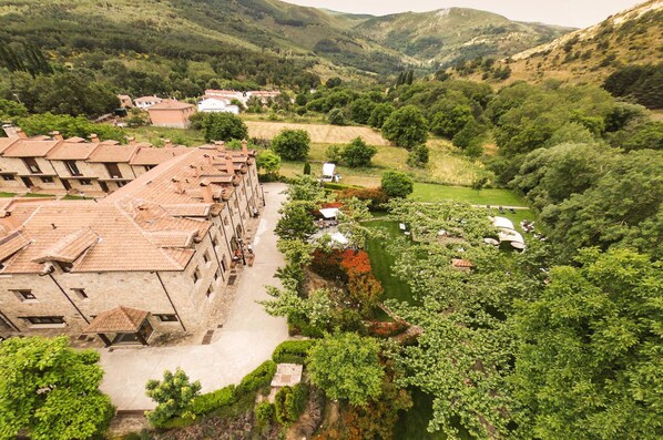 A terraced building with a courtyard and a river.