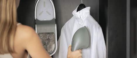 A person holding a white garment near a scale, possibly weighing it.