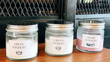 Three glass jars with labels on a wooden surface.