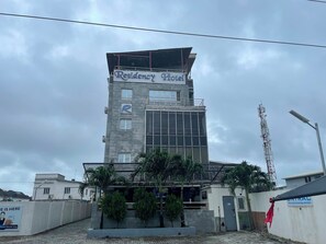 A multi-story building with a sign reading 'Residency Hotel' and a logo with an 'R'. - Residency Hotel Lekki Lagos (Lekki)