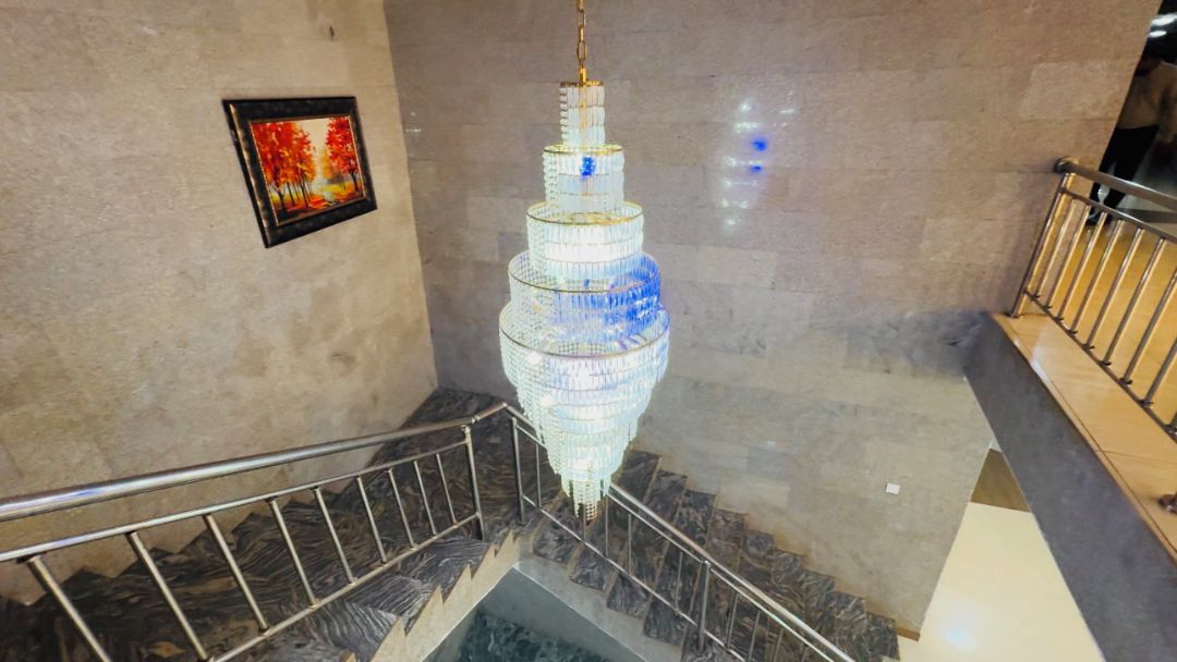 A spiral staircase with a chandelier.