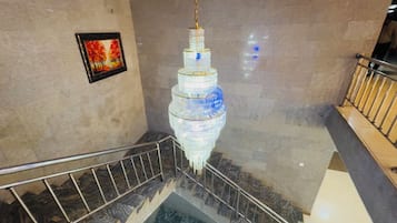 A spiral staircase with a chandelier.